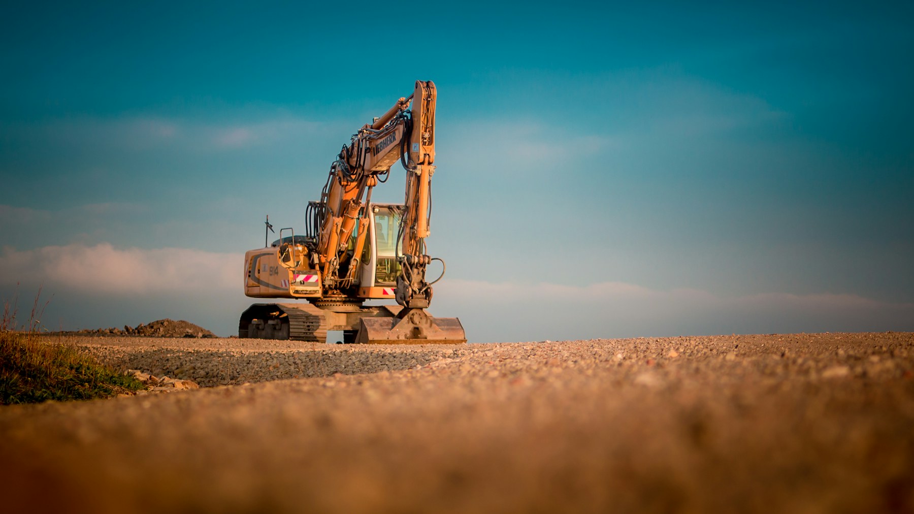 Yellow excavator ready for work on a gravel site